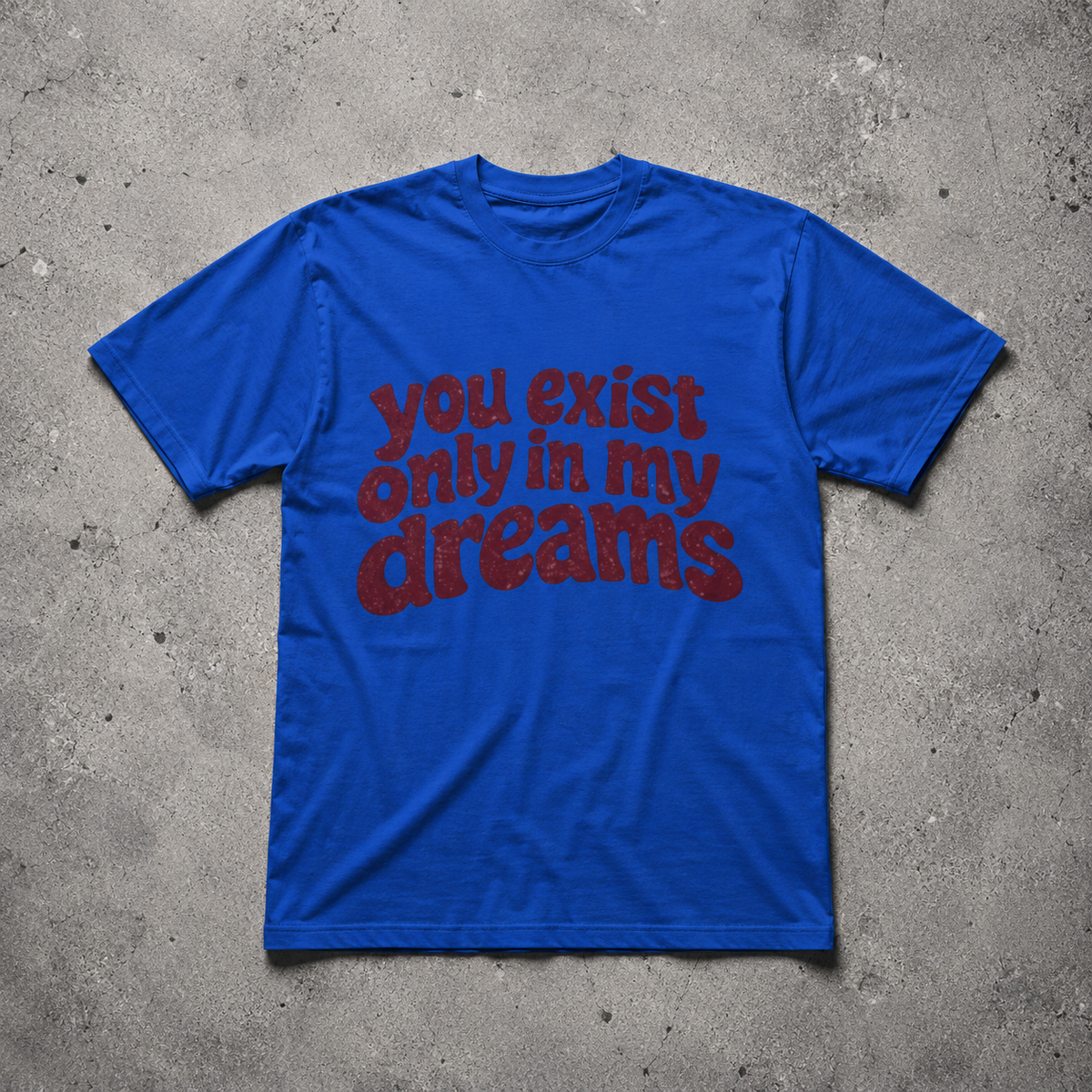 You Exist Only In My Dreams Tee royal blue oversized 
vintage graphic t-shirt flat lay on concrete — retro bubble 
letter screen print, Nostalgic Misfits limited drop streetwear