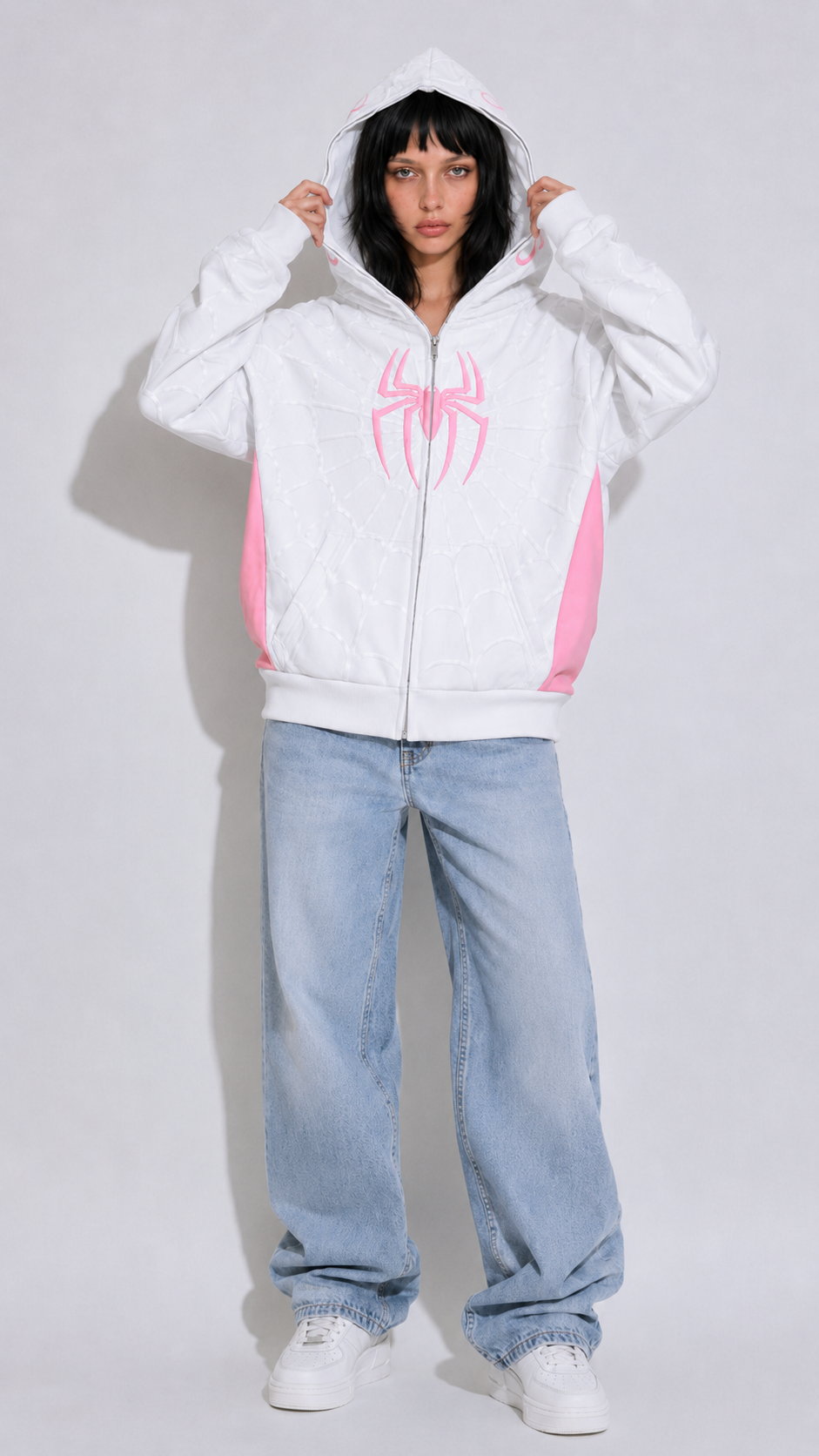Nostalgic Misfits Ghost Zip white pink spidey hoodie front view female model baggy blue jeans white sneakers hands on hood y2k streetwear style