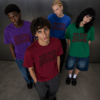 You Exist Only In My Dreams Tee — all four colorways worn 
by group of models, red green blue purple oversized vintage 
screen print t-shirt, Nostalgic Misfits limited drop streetwear