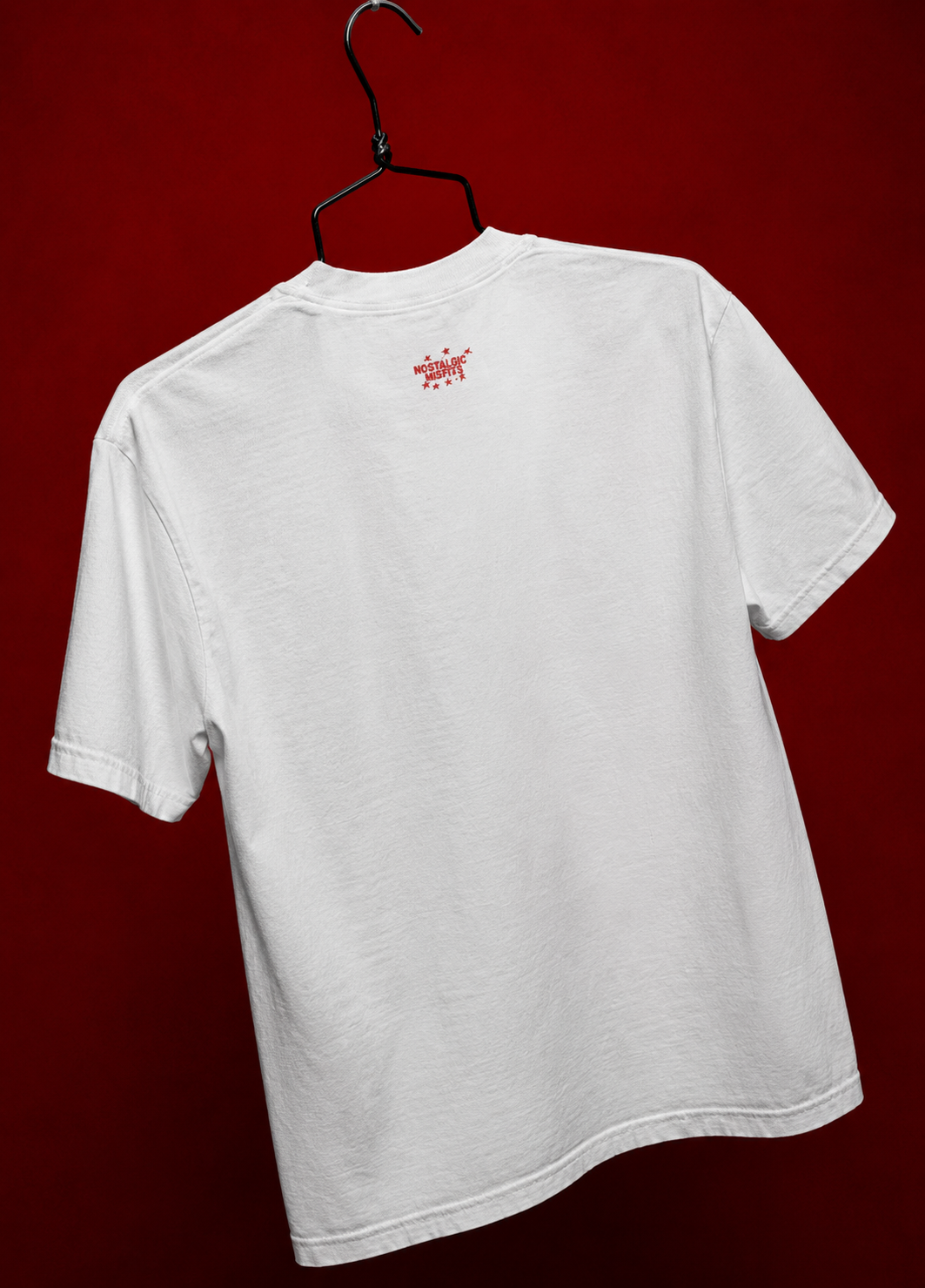 Back view of white oversized Saint Maddy tee with Nostalgic Misfits logo in red — EUPHORIC drop 003