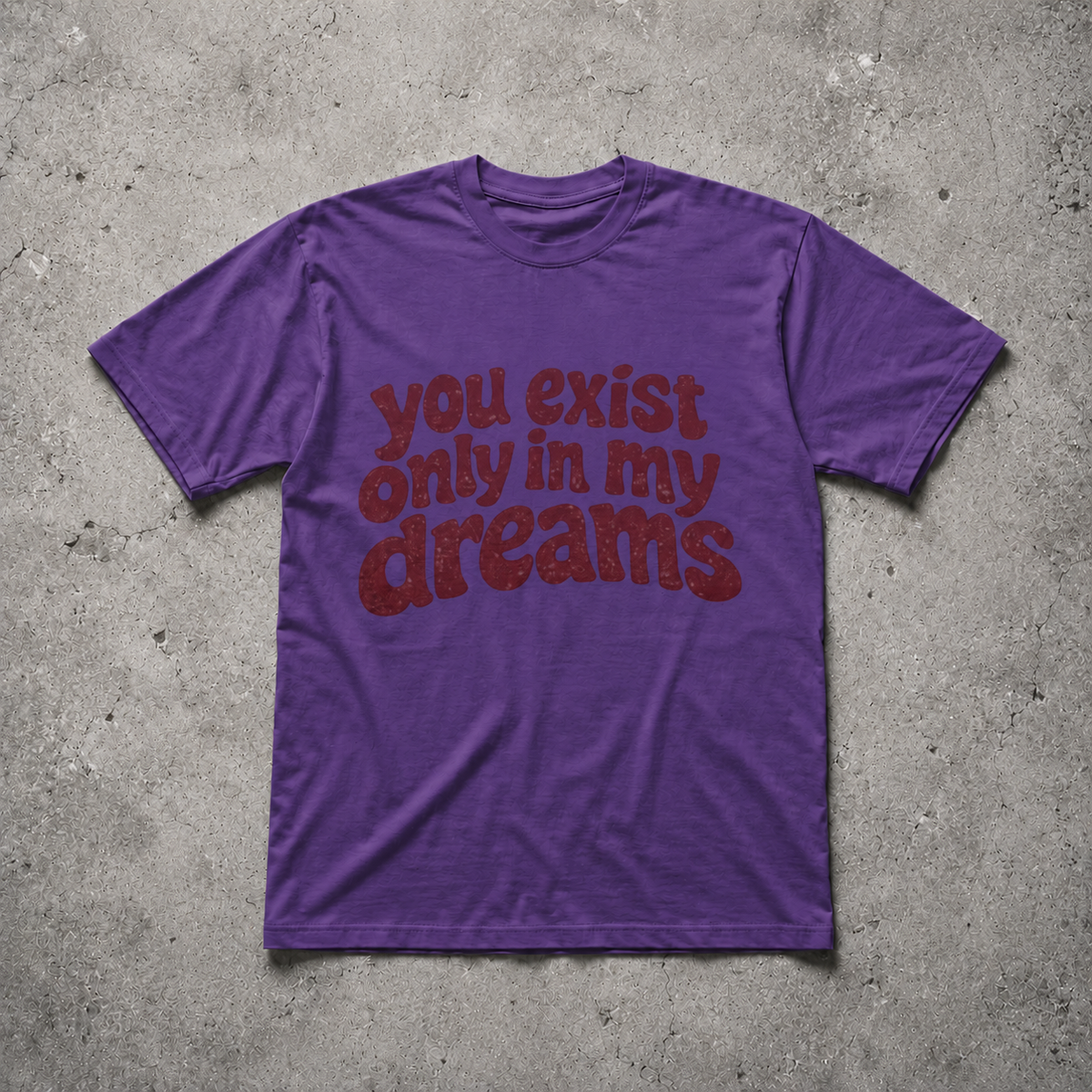 You Exist Only In My Dreams Tee purple oversized vintage 
graphic t-shirt flat lay on concrete — retro bubble letter 
screen print, Nostalgic Misfits limited edition streetwear