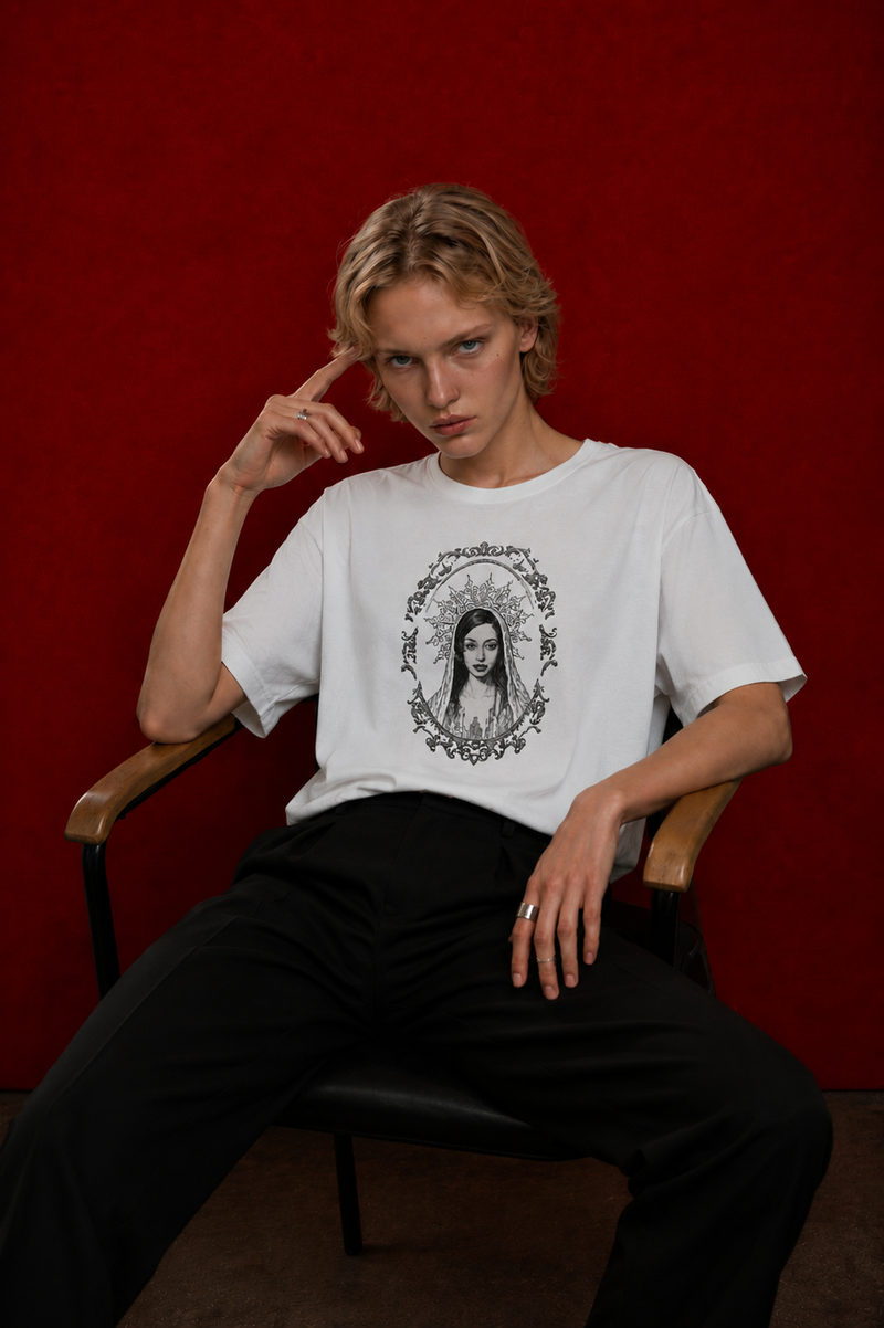 Model wearing Saint Maddy tee, baroque portrait print, seated against deep red background — Nostalgic Misfits EUPHORIC collection