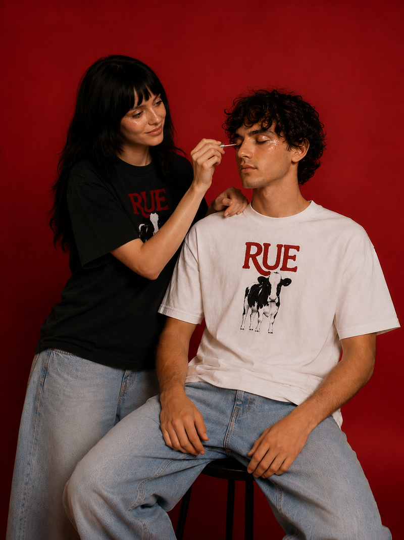 Two models wearing RUE tee in white and black against deep red background - EUPHORIC collection campaign