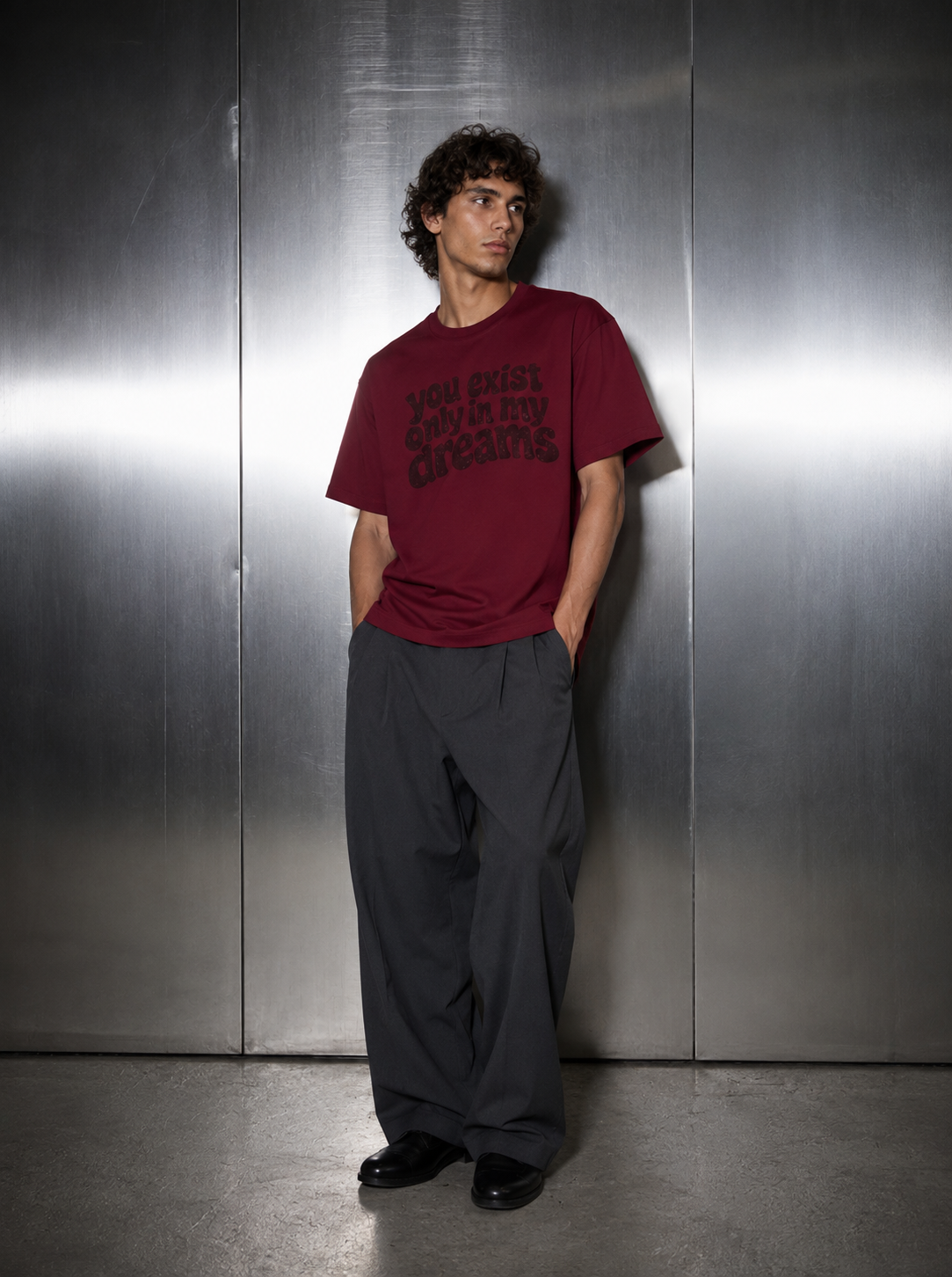 You Exist Only In My Dreams Tee red worn by male model — 
oversized fit, styled with wide leg charcoal trousers 
and black dress shoes, Nostalgic Misfits streetwear